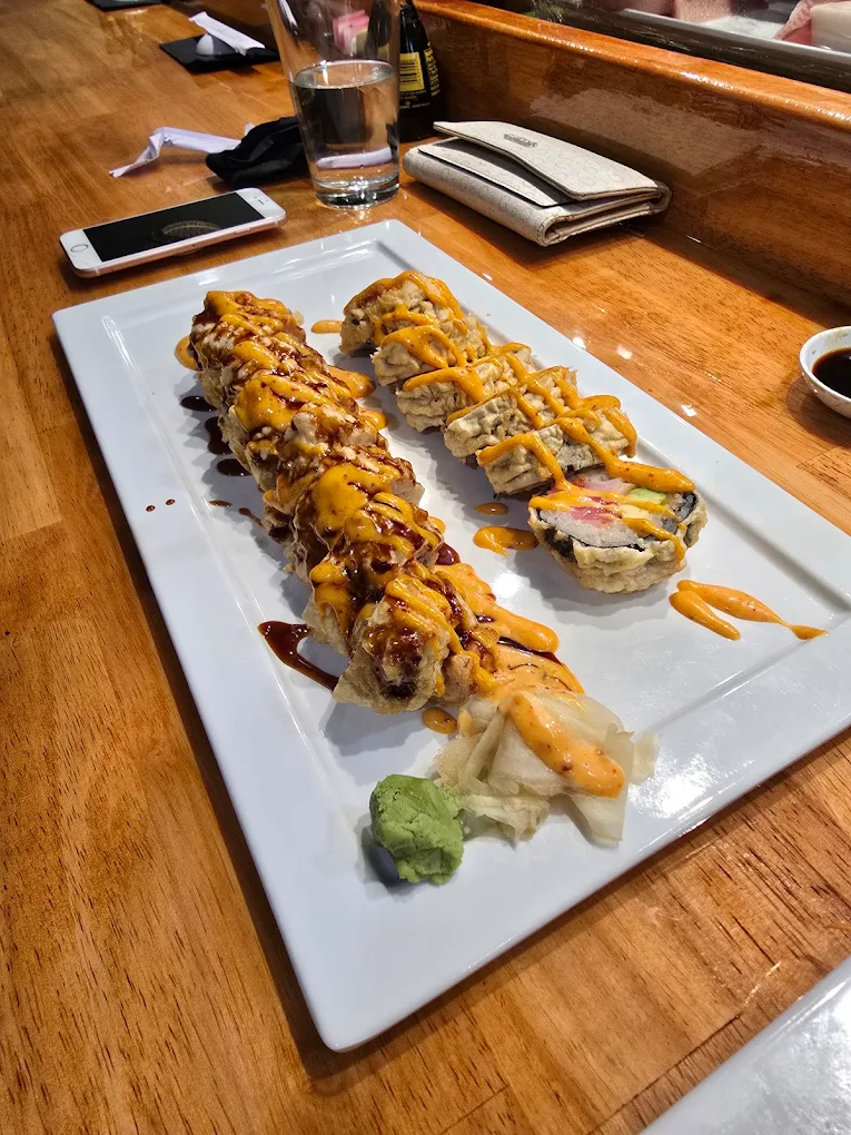 Signature sushi roll with sauce and toppings at Otaka Sushi & Grill, a Asian Fusion Restaurant in Manchester